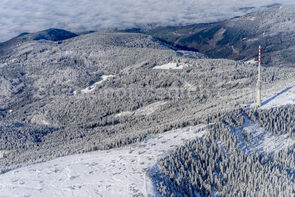 Seebach from above - Wintry snowy Radio tower and transmitter on the crest of the mountain range SWR-Sendeturm on Bergruecken Hornisgrinde in Seebach in the state Baden-Wuerttemberg