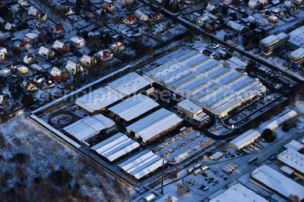 Berlin from above - Wintry snowy building of the construction market of Possling GmbH & Co.KG Mahlsdorf Landsberger Strasse in the district Mahlsdorf in Berlin