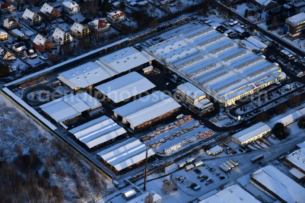 Berlin from the bird's eye view: Wintry snowy building of the construction market of Possling GmbH & Co.KG Mahlsdorf Landsberger Strasse in the district Mahlsdorf in Berlin