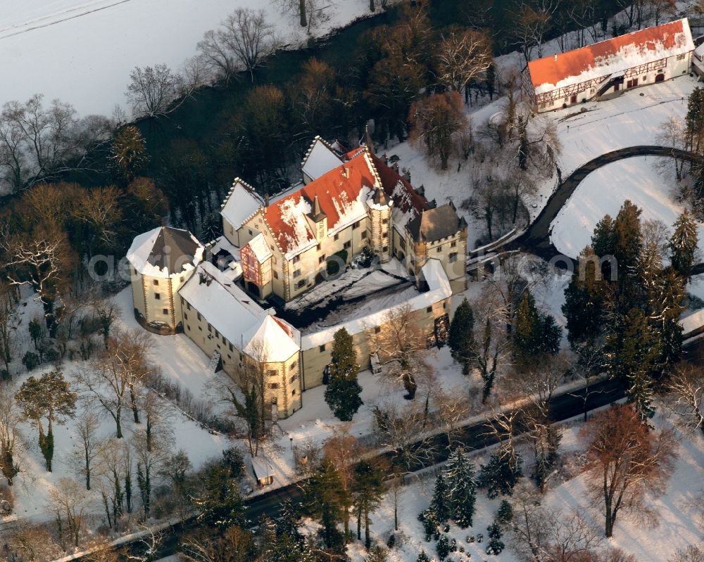 Jagsthausen from above - Wintry snowy castle hotel building Schlosshotel Goetzenburg in Jagsthausen in the state Baden-Wuerttemberg, Germany