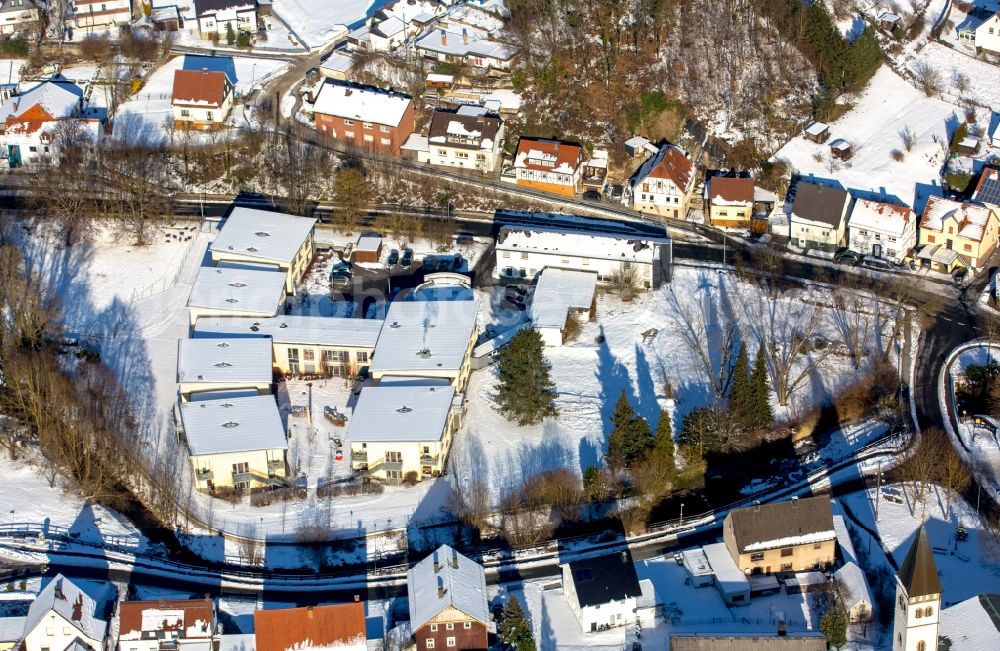 Aerial photograph Marsberg - Wintry snowy buildings of the senior citizen's residence of the old people's home Saint Franziskus in the district of Beringhausen in Mars mountain in the federal state North Rhine-Westphalia