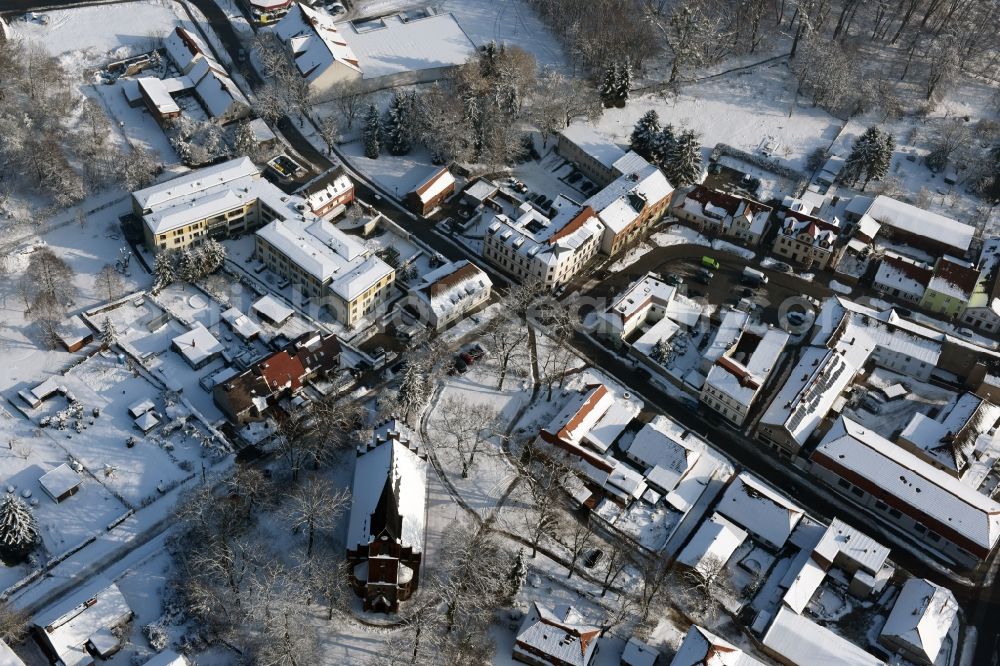 Werneuchen from above - Wintry snowy town Hall building of the City Council at the market downtown in Werneuchen in the state Brandenburg