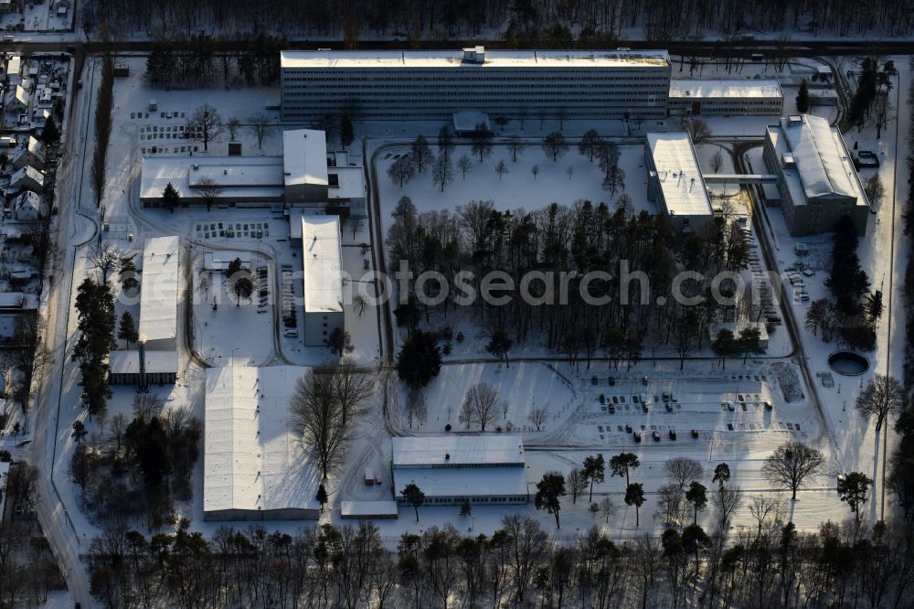 Aerial photograph Berlin - Wintry snowy building complex of the German army - Bundeswehr military barracks of the Planungsamt der Bundeswehr along the Oberspreestrasse in the district Niederschoeneweide in Berlin, Germany