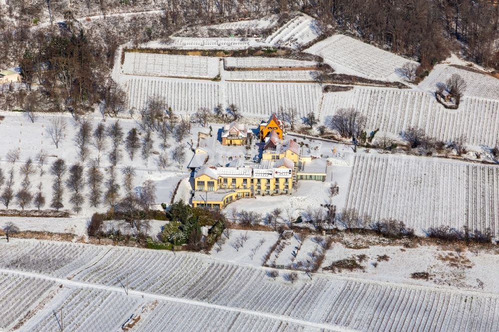 Aerial photograph Rhodt unter Rietburg - Wintry snowy complex of the hotel building Wohlfuehlhotel Alte Rebschule and Gasthaus Sesel in springtime in Rhodt unter Rietburg in the state Rhineland-Palatinate, Germany