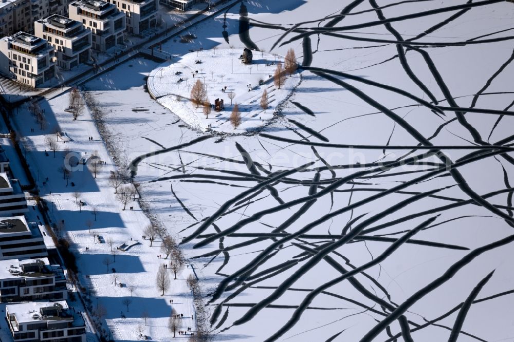 Dortmund from above - Wintry snowy traces on the frozen and ice-covered water surface PhoenixSee in the district Hoerde in Dortmund at Ruhrgebiet in the state North Rhine-Westphalia, Germany