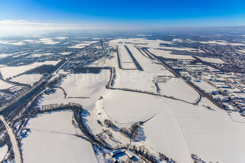 Aerial image Dortmund - Wintry snowy runway with hangar taxiways and terminals on the grounds of the airport in Dortmund in the state North Rhine-Westphalia, Germany