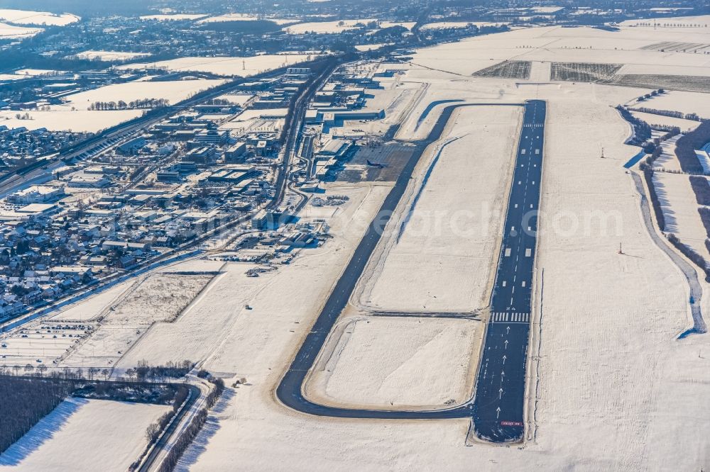 Aerial image Dortmund - Wintry snowy runway with hangar taxiways and terminals on the grounds of the airport in Dortmund in the state North Rhine-Westphalia, Germany