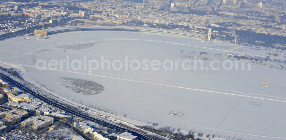 Aerial image Berlin - Wintry snowy runway with hangar taxiways and terminals on the grounds of the airport in the district Tempelhof in Berlin, Germany