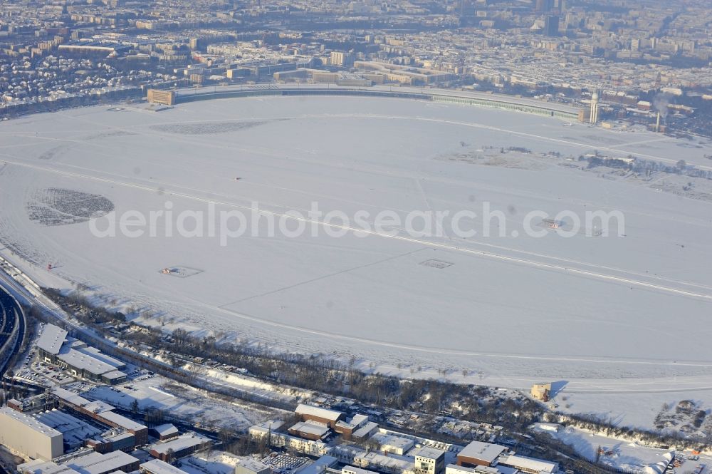 Berlin from the bird's eye view: Wintry snowy runway with hangar taxiways and terminals on the grounds of the airport in the district Tempelhof in Berlin, Germany