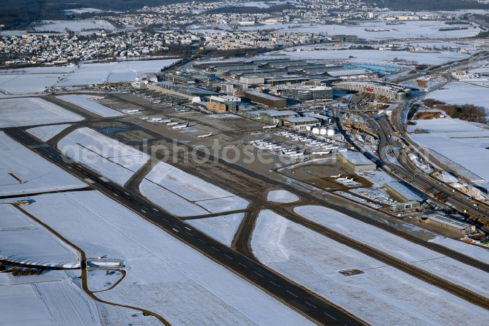 Aerial image Stuttgart - Wintry snowy runway with hangar taxiways and terminals on the grounds of the airport in Stuttgart in the state Baden-Wuerttemberg, Germany