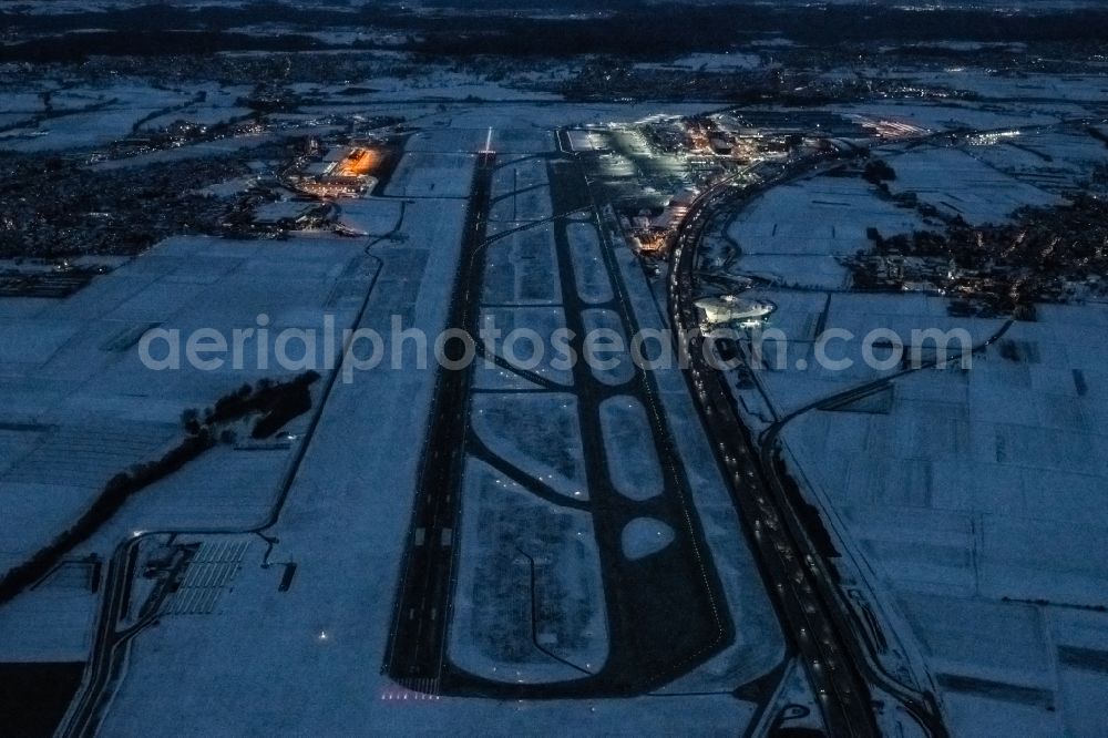 Aerial image Stuttgart - Wintry snowy runway with hangar taxiways and terminals on the grounds of the airport in Stuttgart in the state Baden-Wuerttemberg, Germany