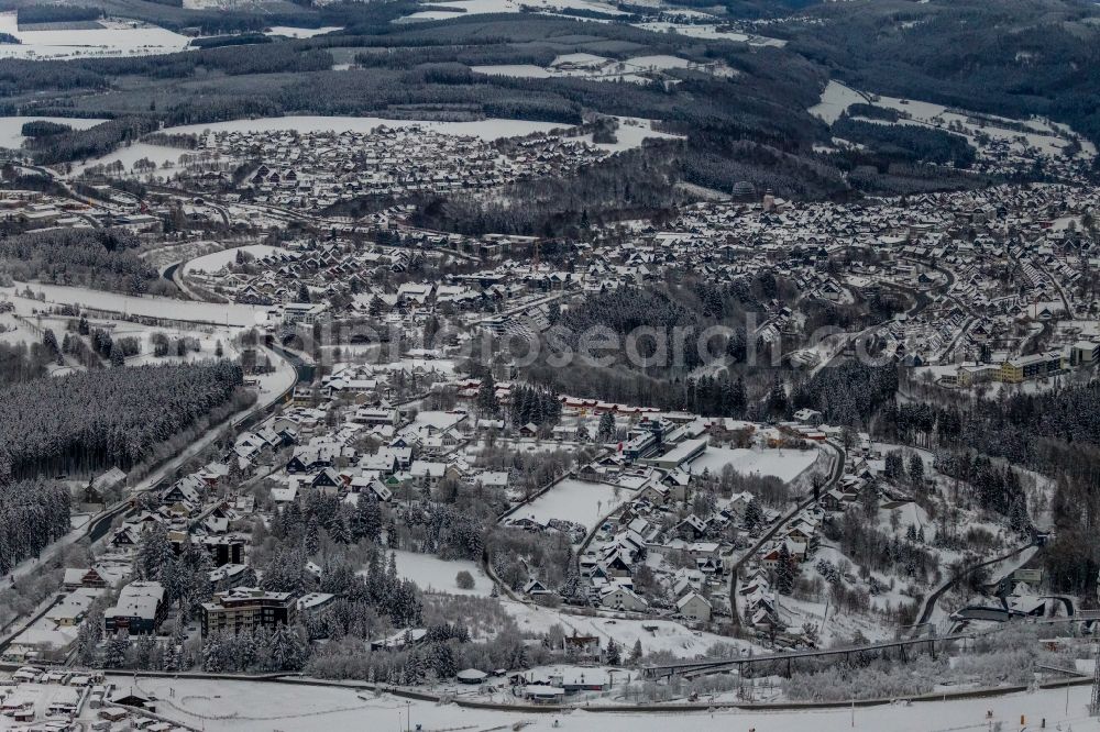 Winterberg from the bird's eye view: Wintry snowy city area with outside districts and inner city area in Winterberg at Sauerland in the state North Rhine-Westphalia, Germany