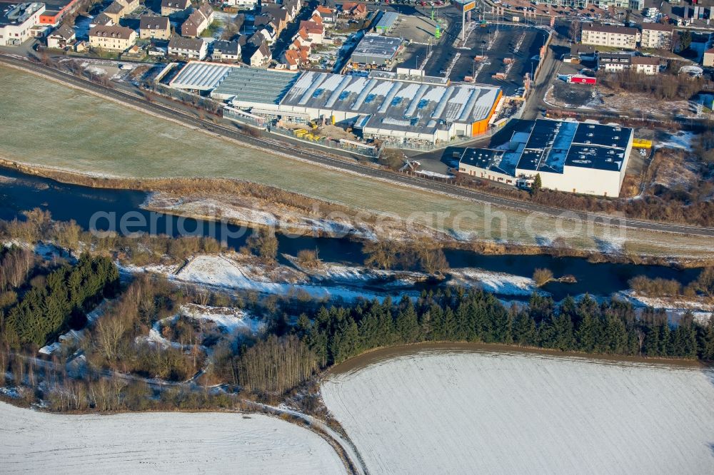 Arnsberg from above - Wintry snowy Industrial estate and company settlement Arnsberger Strasse on the banks of the river Ruhr in the district Huesten in Arnsberg in the state North Rhine-Westphalia