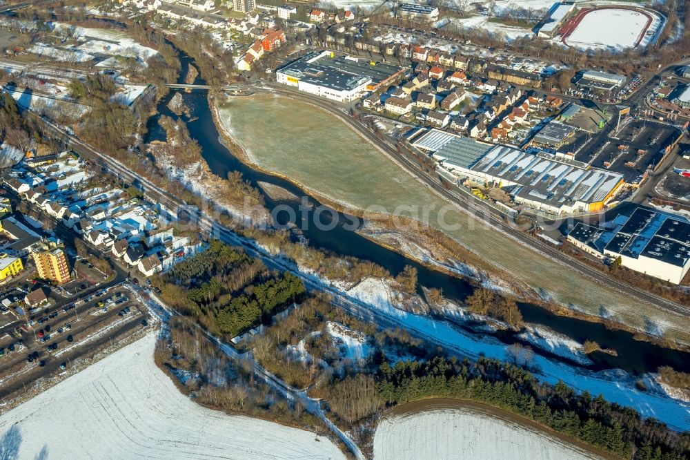 Aerial image Arnsberg - Wintry snowy Industrial estate and company settlement Arnsberger Strasse on the banks of the river Ruhr in the district Huesten in Arnsberg in the state North Rhine-Westphalia