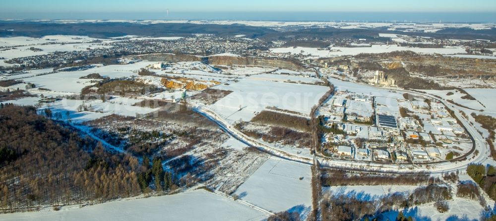 Warstein from the bird's eye view: Wintry snowy Industrial estate and company settlement Enkerbruch in Warstein in the state North Rhine-Westphalia