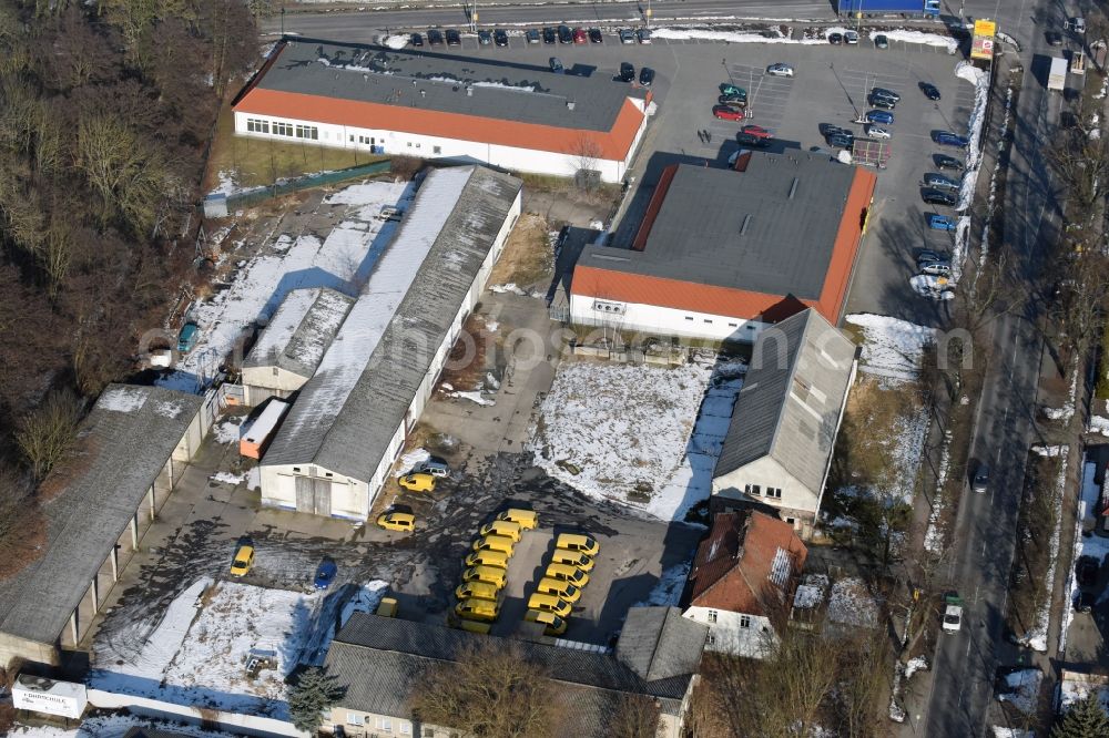 Werneuchen from the bird's eye view: Wintry snowy Industrial estate and company settlement Freienwalder Strasse in Werneuchen in the state Brandenburg