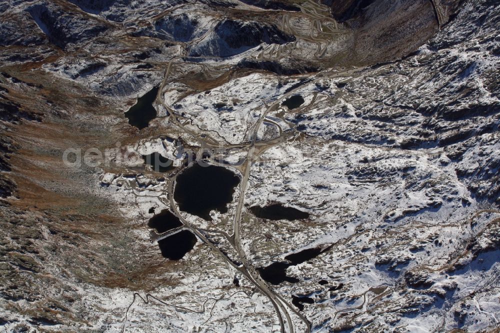 Aerial photograph Airolo - Wintry snowy Mountain pass San Gottardo and Lake Lago della Piazza in Airolo in the canton Ticino, Switzerland