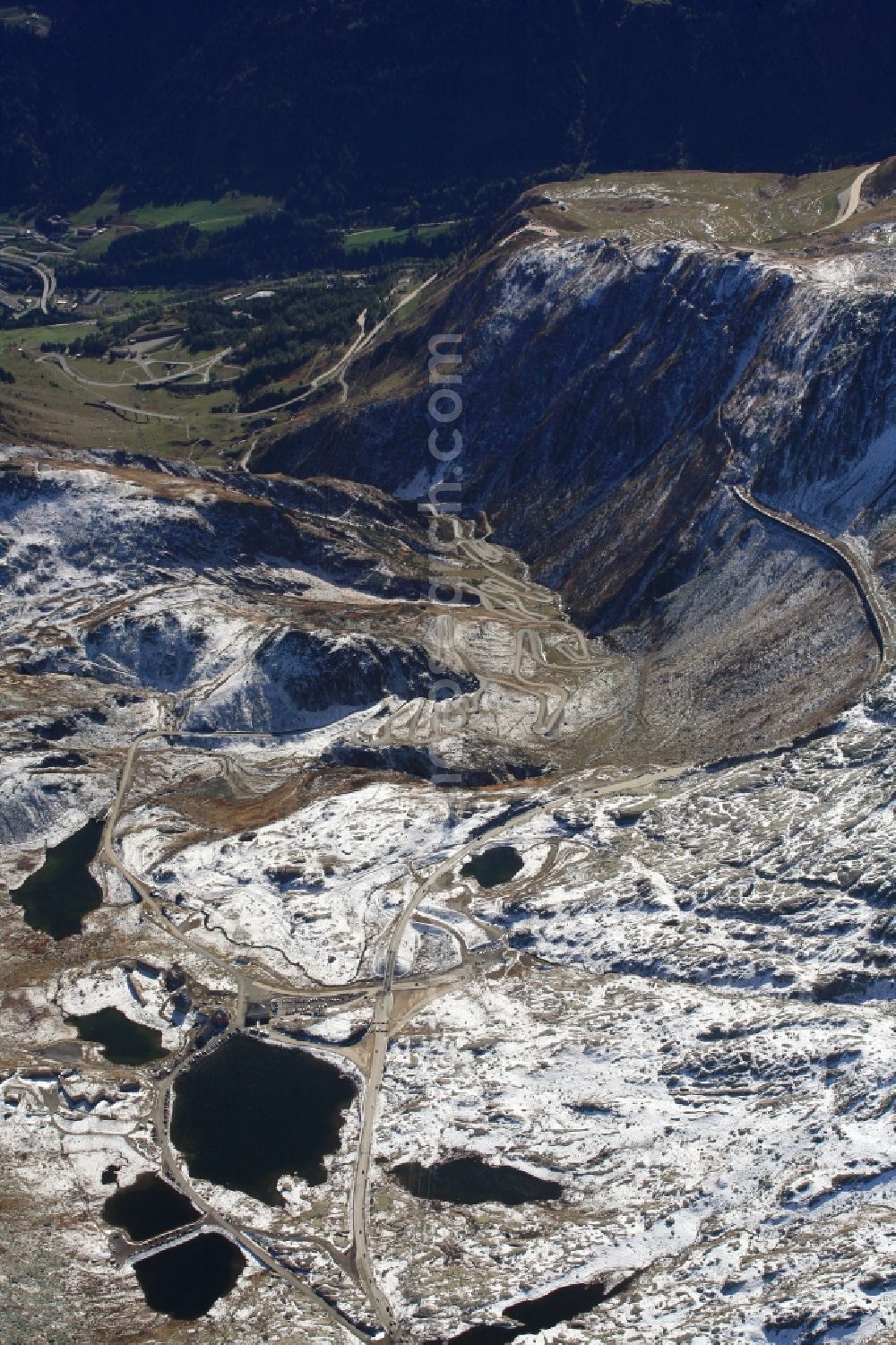 Airolo from above - Wintry snowy Mountain pass San Gottardo and Lake Lago della Piazza in Airolo in the canton Ticino, Switzerland