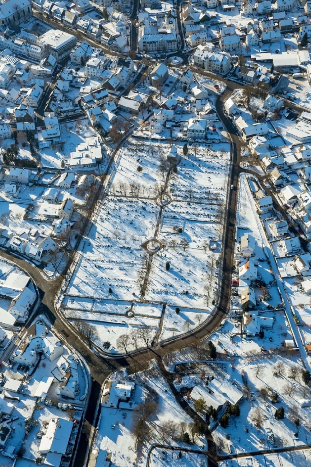 Brilon from the bird's eye view: Wintry snowy Grave rows on the grounds of the cemetery in Brilon in the state North Rhine-Westphalia