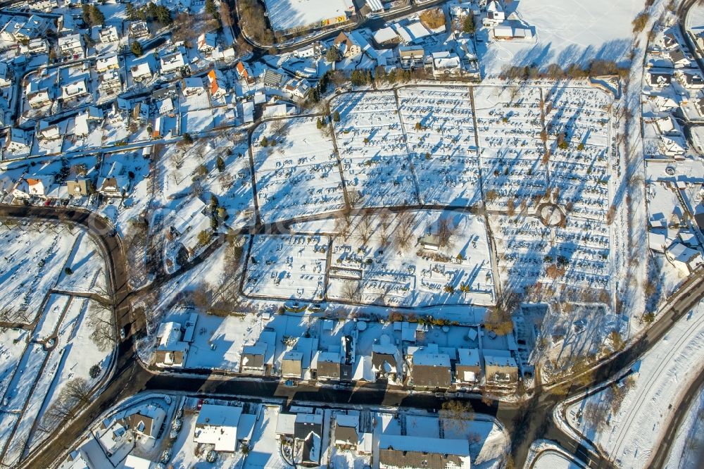 Brilon from the bird's eye view: Wintry snowy Grave rows on the grounds of the cemetery St. Martin in Brilon in the state North Rhine-Westphalia