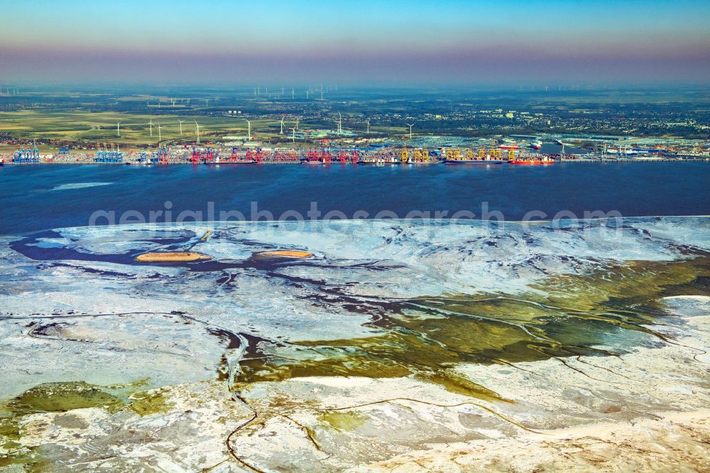 Bremerhaven from above - Wintry snowy docks and terminals with warehouses, freight forwarding and logistics companies and lots of containers by the mouth of the Weser in Bremerhaven in the state Bremen