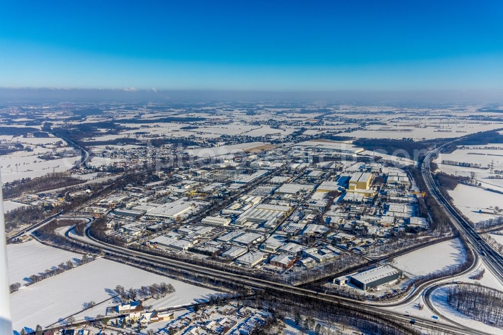 Unna from the bird's eye view: Wintry snowy industrial and commercial area on Einsteinstrasse - Alfred-Nobel-Strasse in the district Industriepark Unna in Unna at Ruhrgebiet in the state North Rhine-Westphalia, Germany