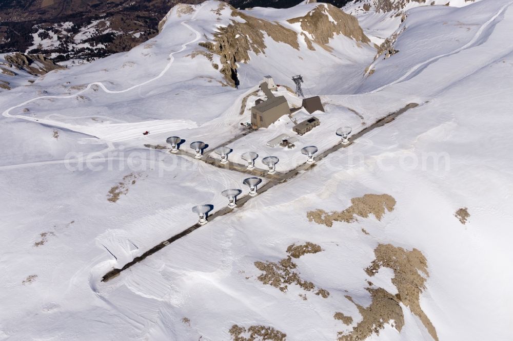 Aerial photograph Le Devoluy - Wintry snowy interferometer on the mountain pic de bure in Le Devoluy in Provence-Alpes-Cote d'Azur, France. It is specifically designed for millimetre-wave observations