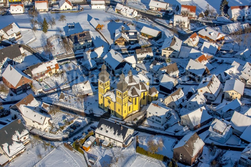 Marsberg from the bird's eye view: Wintry snowy church building of the cathedral of Dom Maria-Magdalena in the district Padberg in Marsberg in the state North Rhine-Westphalia