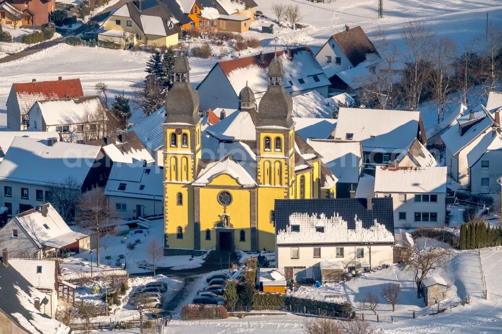 Marsberg from above - Wintry snowy church building of the cathedral of Dom Maria-Magdalena in the district Padberg in Marsberg in the state North Rhine-Westphalia