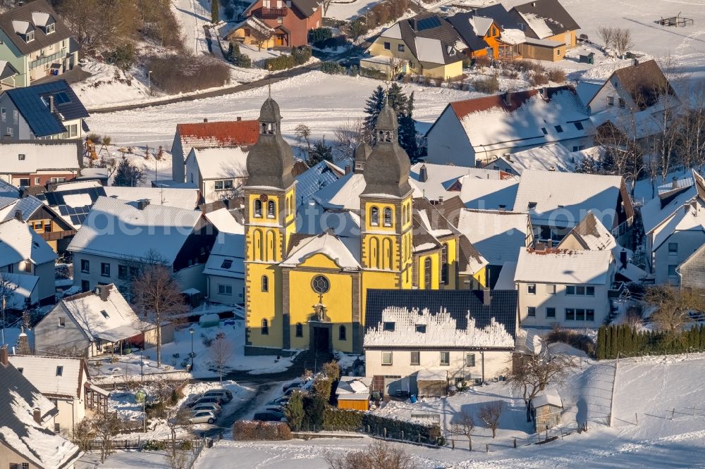 Marsberg from the bird's eye view: Wintry snowy church building of the cathedral of Dom Maria-Magdalena in the district Padberg in Marsberg in the state North Rhine-Westphalia