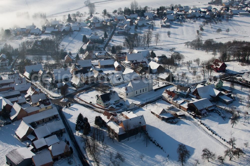 Aerial photograph Eberbach-Seltz - Wintry snowy Church building in the village of in Eberbach-Seltz in Grand Est, France