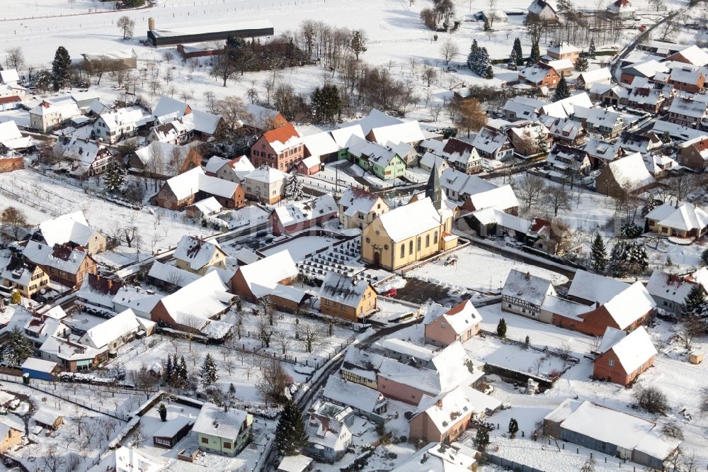 Oberlauterbach from the bird's eye view: Wintry snowy Church building in the village of in Oberlauterbach in Grand Est, France