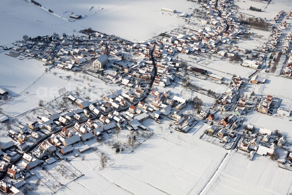 Aerial image Schleithal - Wintry snowy Church building in the village of in Schleithal in Grand Est, France