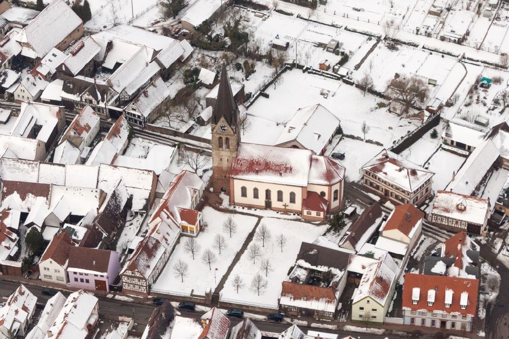 Steinweiler from above - Wintry snowy Catholic Church building in the village of in Steinweiler in the state Rhineland-Palatinate, Germany