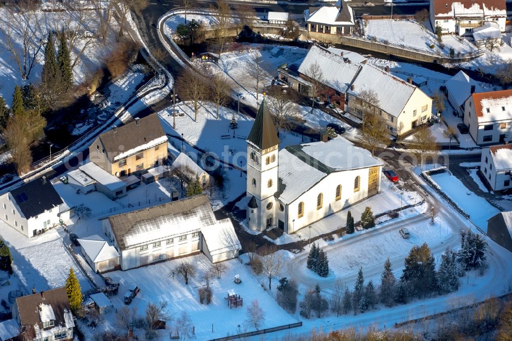 Aerial photograph Marsberg - Wintry snowy church buildings Saint Markus Pfarr churchin the district of Beringhausen in Marsberg in the federal state North Rhine-Westphalia