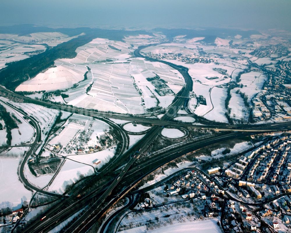 Aerial image Weinsberg - Wintry snowy traffic flow at the intersection- motorway A 81 - 6 Autobahnkreuz Weinsberg in form of cloverleaf in Weinsberg in the state Baden-Wuerttemberg, Germany