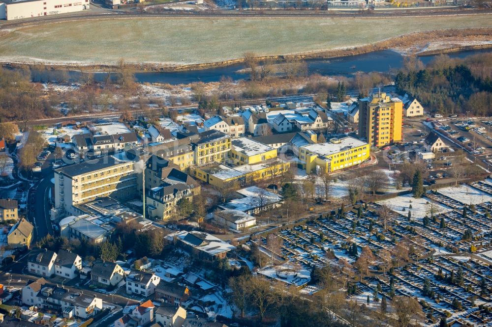 Arnsberg from the bird's eye view: Wintry snowy Hospital grounds of the Clinic Karolinen-Hospital in the district Huesten in Arnsberg in the state North Rhine-Westphalia