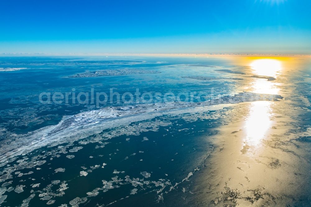 Langeneß from the bird's eye view: Wintry snowy coastal area of the North Sea- Island in Langeness in the state Schleswig-Holstein