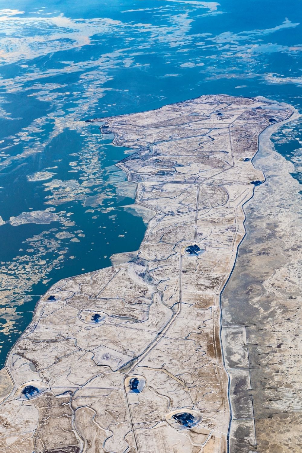 Langeneß from the bird's eye view: Wintry snowy coastal area of the North Sea- Island in Langeness in the state Schleswig-Holstein