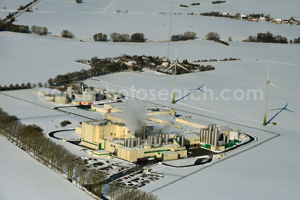 Klatzow from above - Wintry snowy buildings and production halls on the food manufacturer's premises DMK Deutsches Milchkontor GmbH in Klatzow in the state Mecklenburg - Western Pomerania, Germany