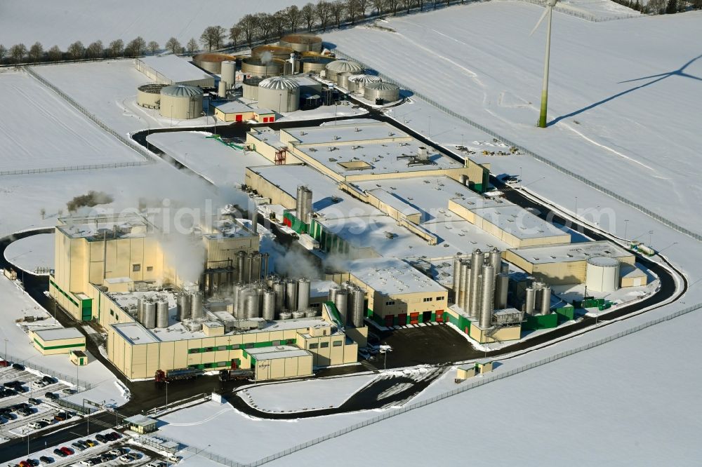 Klatzow from above - Wintry snowy buildings and production halls on the food manufacturer's premises DMK Deutsches Milchkontor GmbH in Klatzow in the state Mecklenburg - Western Pomerania, Germany