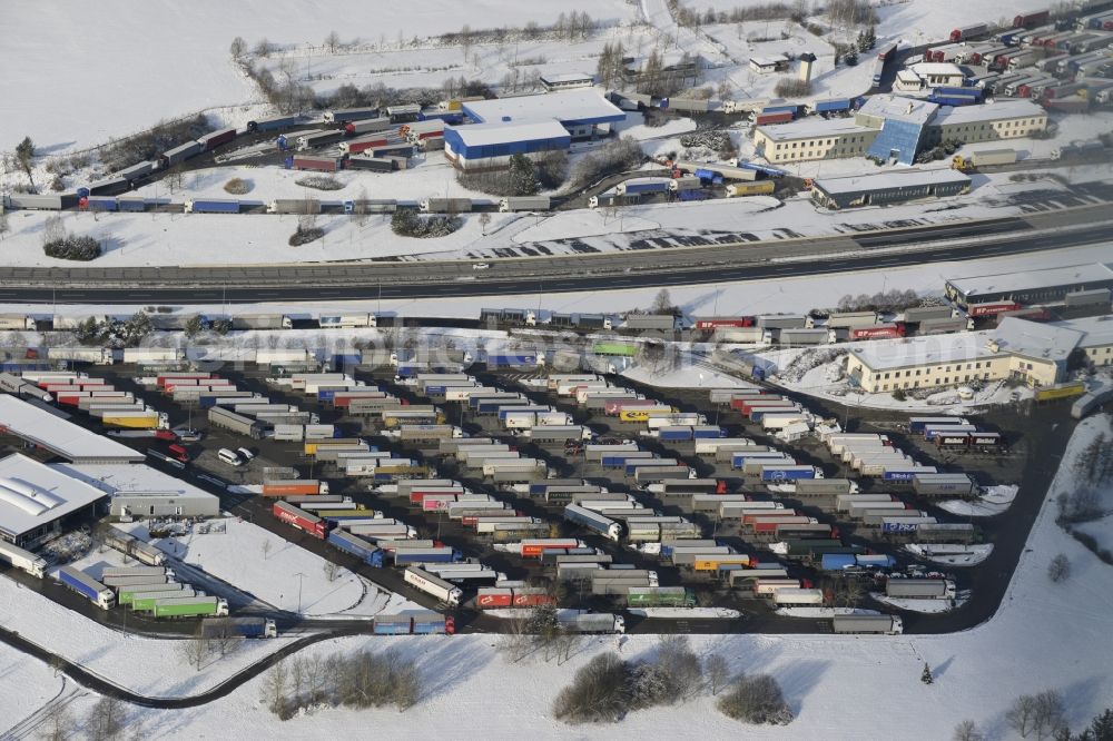 Waidhaus from above - Wintry snowy lorries - parking spaces at the highway rest stop and parking of the BAB A 6 - E50 in Waidhaus in the state Bavaria, Germany