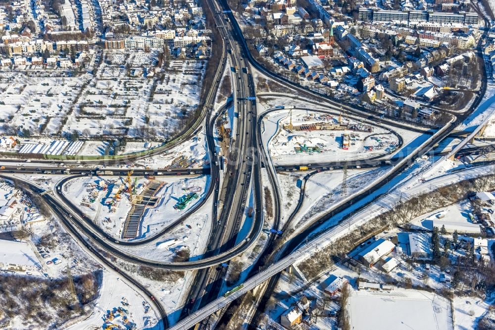 Herne from above - Wintry snowy aerial view of the motorway junction Herne with construction site for the new routing in the course of the motorway tunnel construction at the junction Herne of the BAB 42 - 43 Tunnel Baukau in Herne in the federal state North Rhine-Westphalia, Germany.