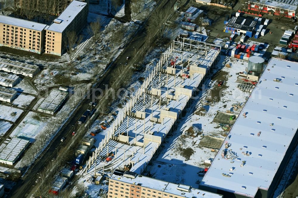 Berlin from the bird's eye view: Wintry snowy new building construction site in the industrial park Wollenberger Strasse in the district Hohenschoenhausen in Berlin, Germany