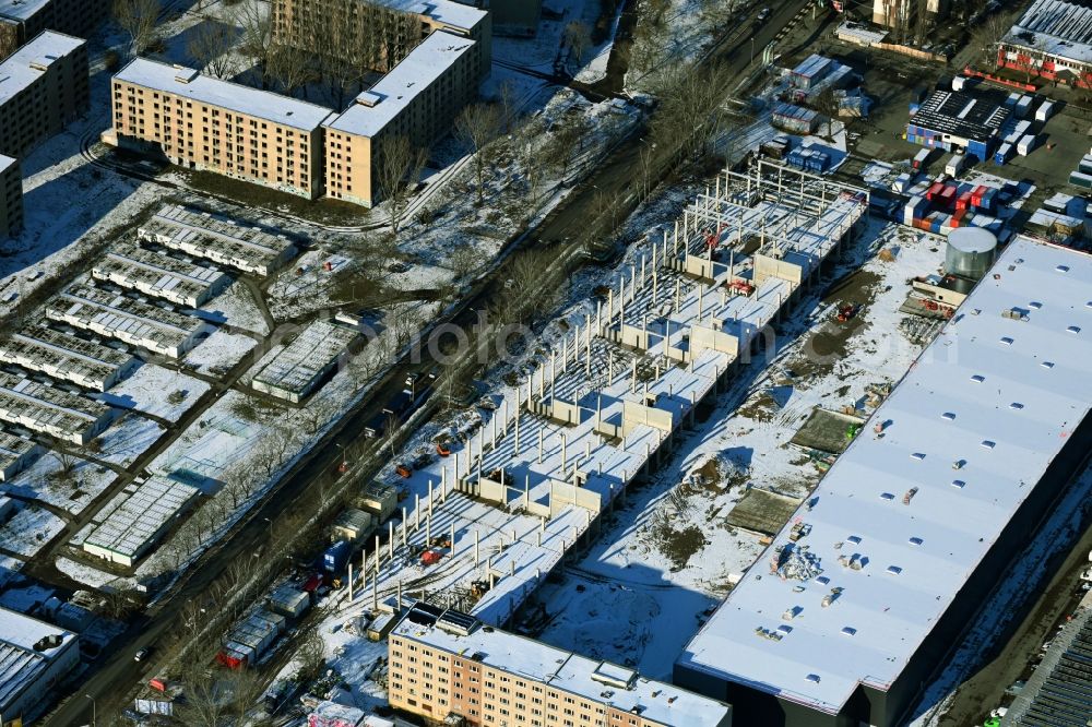 Aerial image Berlin - Wintry snowy new building construction site in the industrial park Wollenberger Strasse in the district Hohenschoenhausen in Berlin, Germany