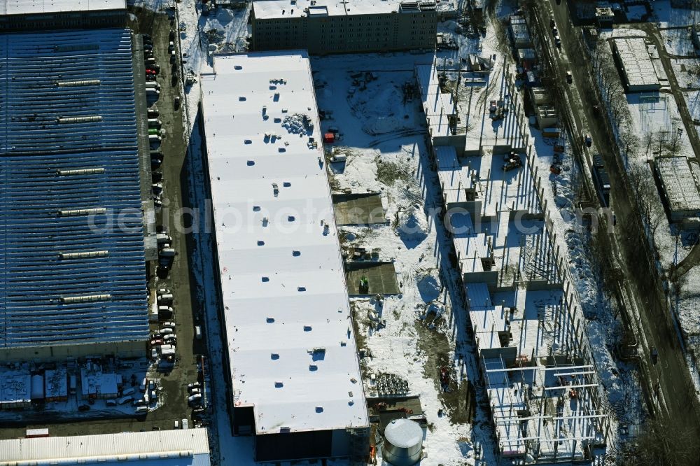 Aerial image Berlin - Wintry snowy new building construction site in the industrial park Wollenberger Strasse in the district Hohenschoenhausen in Berlin, Germany