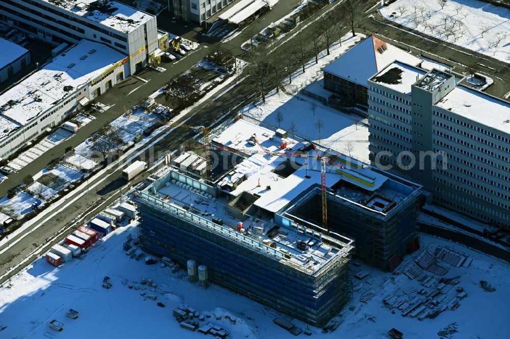 Aerial photograph Berlin - Wintry snowy construction site to build a new office and commercial building on Beilsteiner Strasse in the district Marzahn in Berlin, Germany