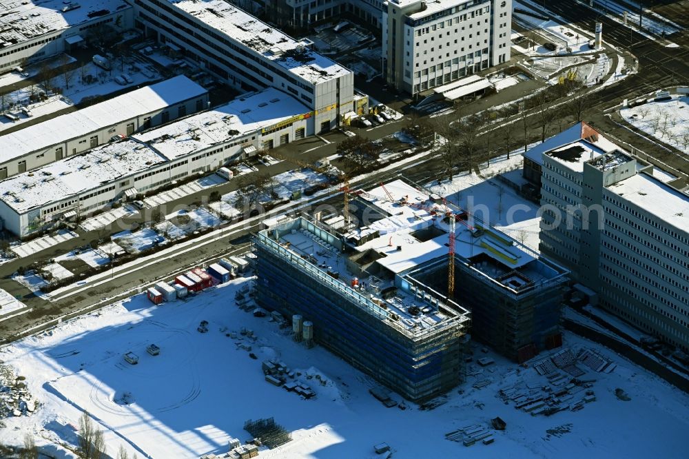 Aerial image Berlin - Wintry snowy construction site to build a new office and commercial building on Beilsteiner Strasse in the district Marzahn in Berlin, Germany