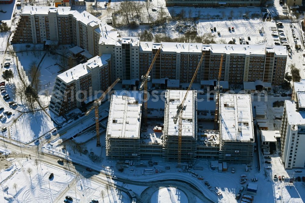 Aerial image Rostock - Wintry snowy construction site to build a new office and commercial building on Bahnhofsvorplatz in the district Suedstadt in Rostock in the state Mecklenburg - Western Pomerania, Germany