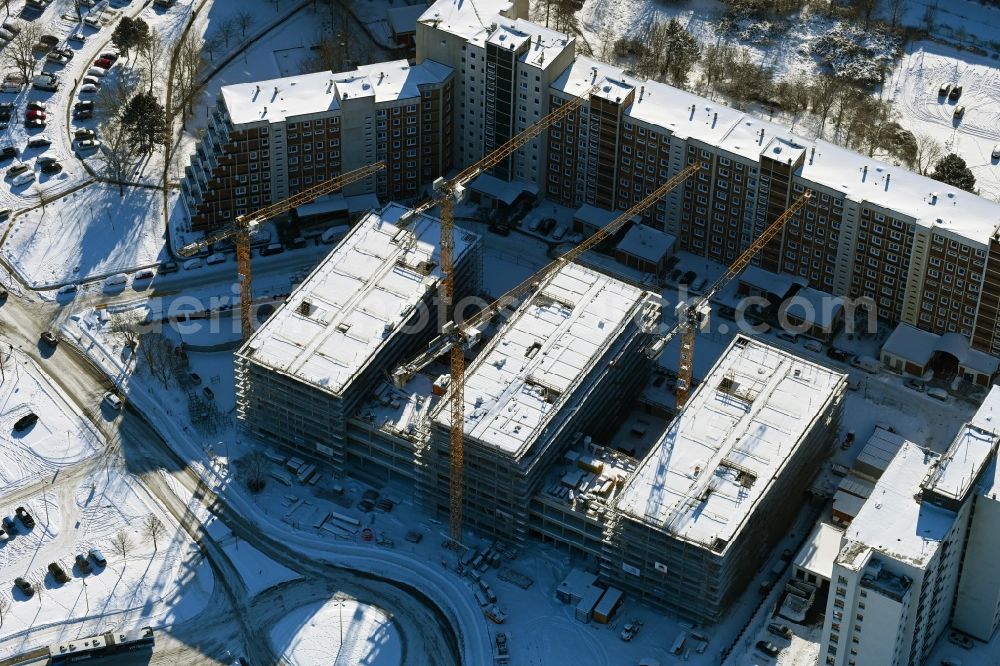 Aerial image Rostock - Wintry snowy construction site to build a new office and commercial building on Bahnhofsvorplatz in the district Suedstadt in Rostock in the state Mecklenburg - Western Pomerania, Germany